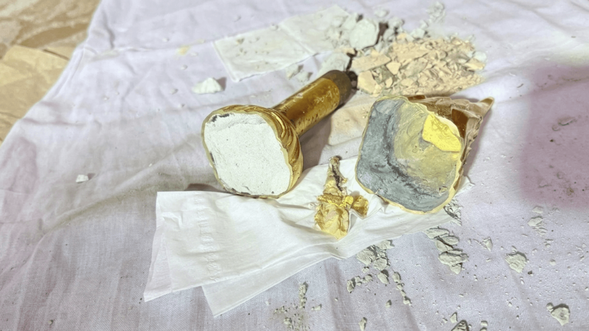 Tears of relief as 'missing' gold found inside Buddha topknot